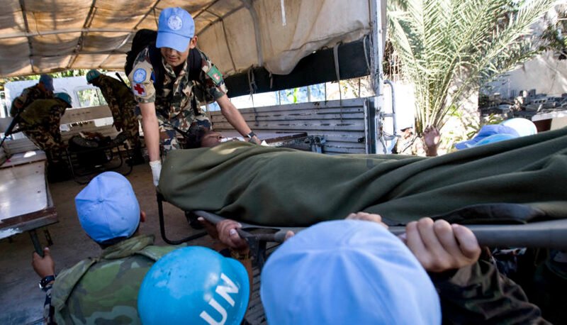 United Nations peacekeepers load an injured person into a truck after the 2010 earthquake in Haiti.