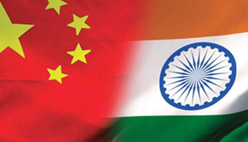 The flags of China and India fading into each other.