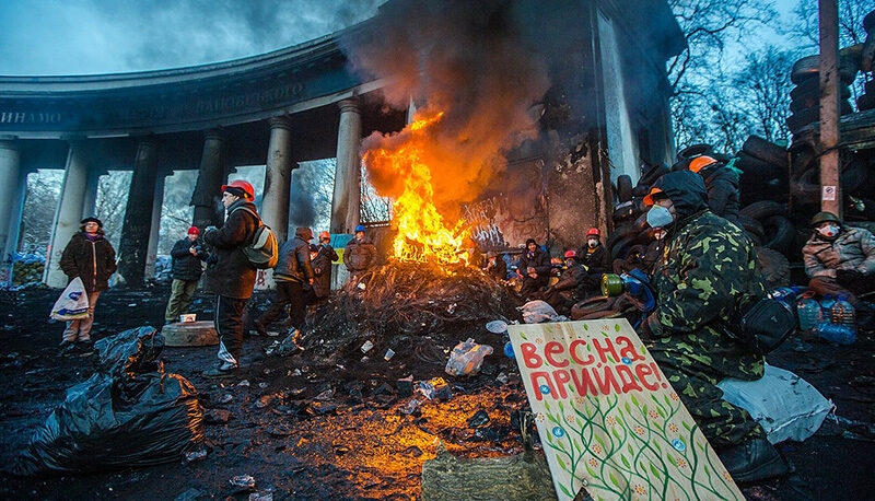 Barricade with the protesters at Hrushevskogo street on January 26, 2014 in Kiev, Ukraine. The protesters have a sign reading, "Spring will come" in Russian.