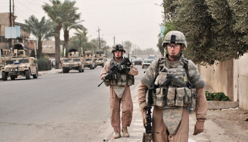 American soldiers perform a walking patrol in Baghdad.