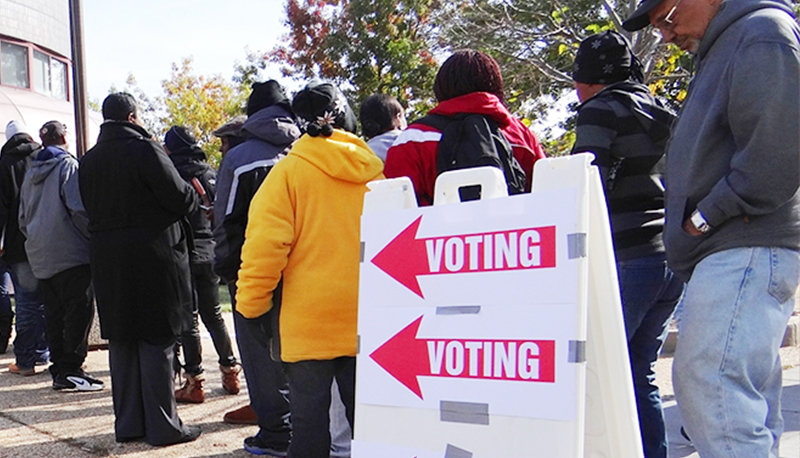 People standing in line to vote with voting sign displayed, Washington, D.C.
