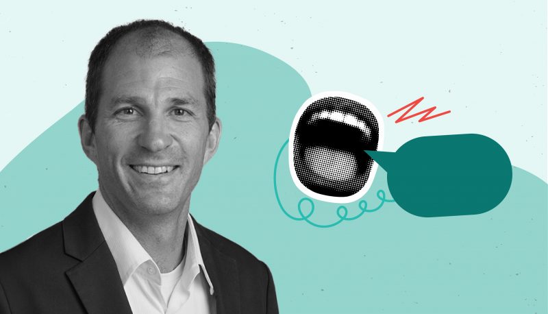 Black and white headshot photo of Zoltan Hajnal next to a clipart image of an open mouth and speech bubble, overlayed on a two-tone teal background