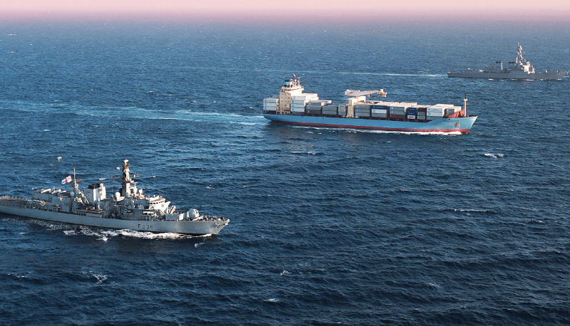 naval and commercial vessels sailing on the open ocean