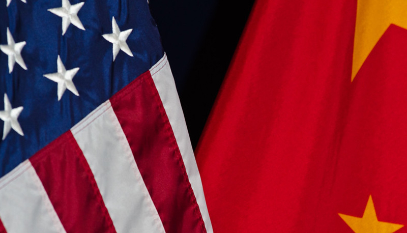 close-up photo of the United States and China national flags side-by-side