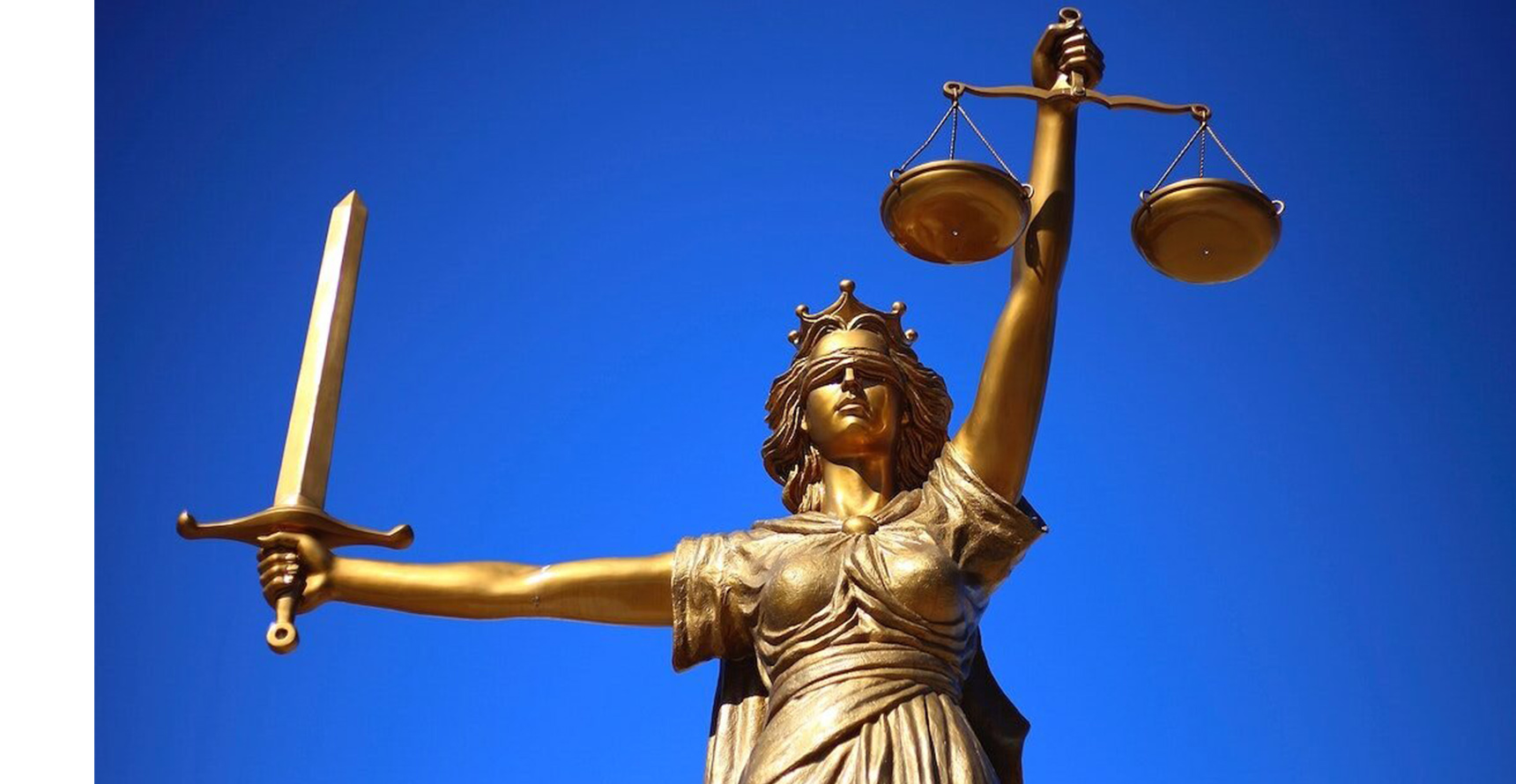 A bronze sculpture depicting Lady Justice, a blindfolded woman holding scales in one hand and a sword in the other, against a blue background.