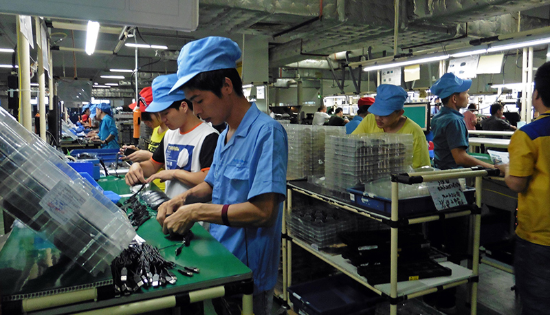 Workers on an assembly line at G.Tech Technology Factory, Zhuhai, China