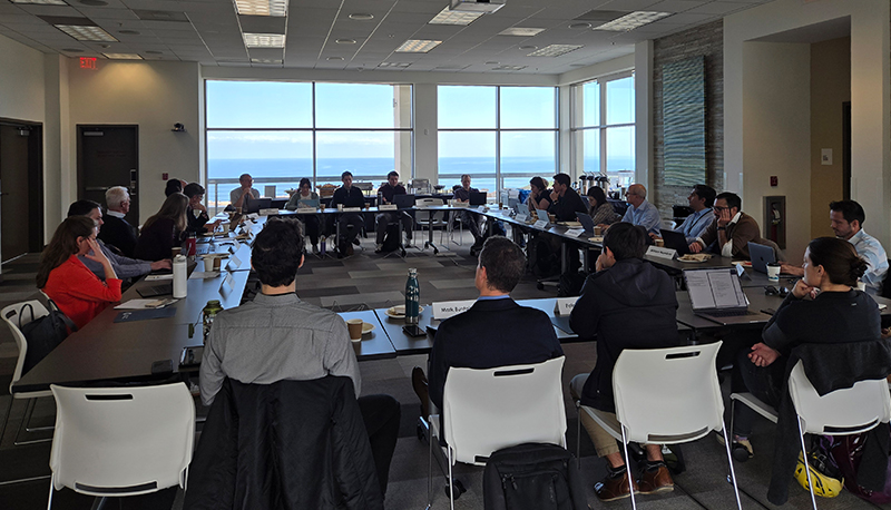 Participants at IGCC's 2025 Climate Change & Democracy research incubator sit around tables engage in discussion