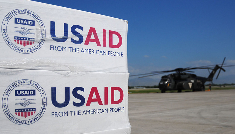 Pallets of food, water and supplies stamped with the USAID logo staged to be delivered