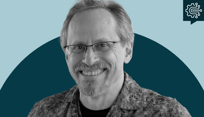 Mark Schwartz headshot on a two-tone blue background