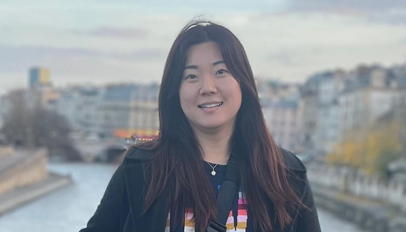 Headshot photo of Emily Kim outdoors in Paris