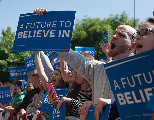 Young voters gather holding signs that read "A Future to Believe In" at a Bernie Sanders Rally in Stockton, CA, 2016.