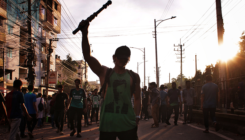 A student raises his arm during mass protests in Bangladesh, 2024