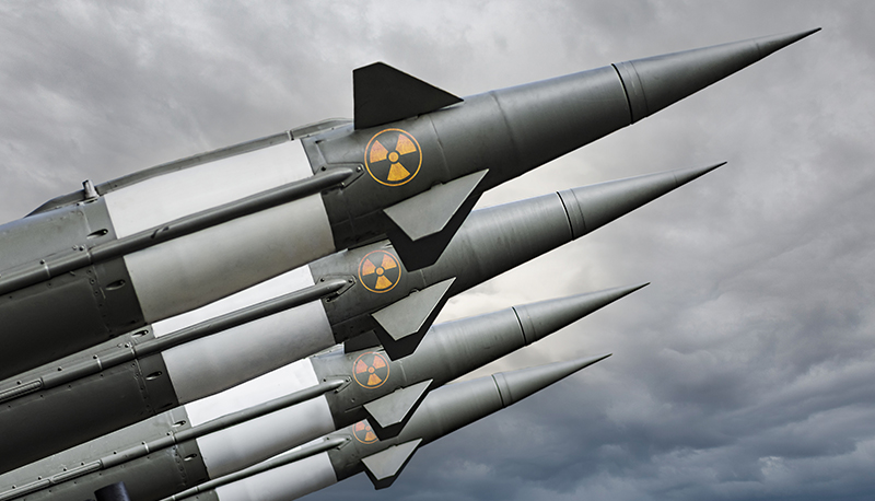 A photo of several nuclear warheads against a gray sky