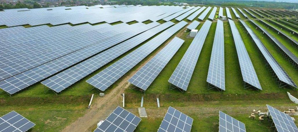 An array of solar panels in a field in Belgium