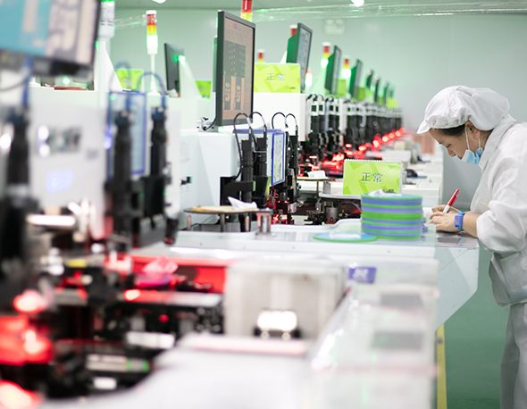 A Chinese factor works on a technology assembly line
