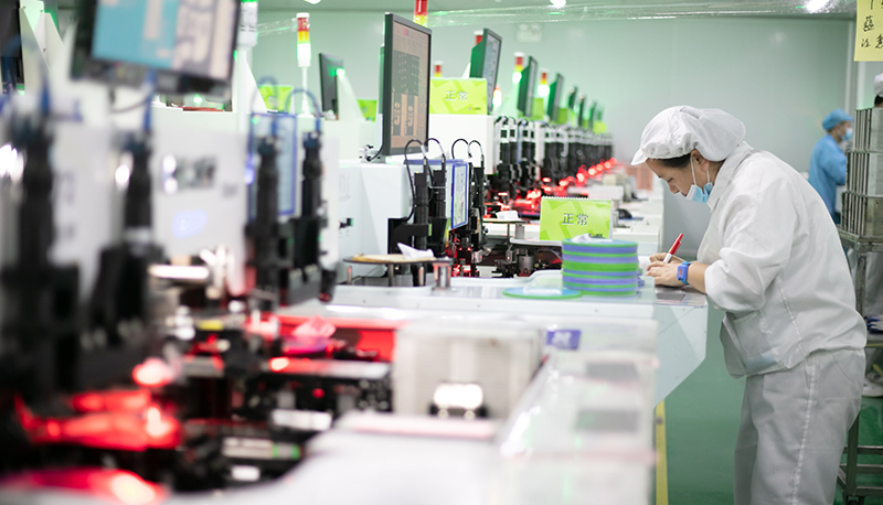 A Chinese factor works on a technology assembly line