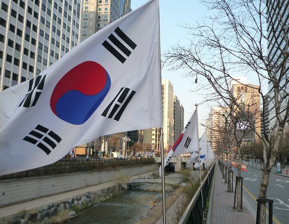 The South Korean flag, flying in the early light over the Cheonggye Stream.