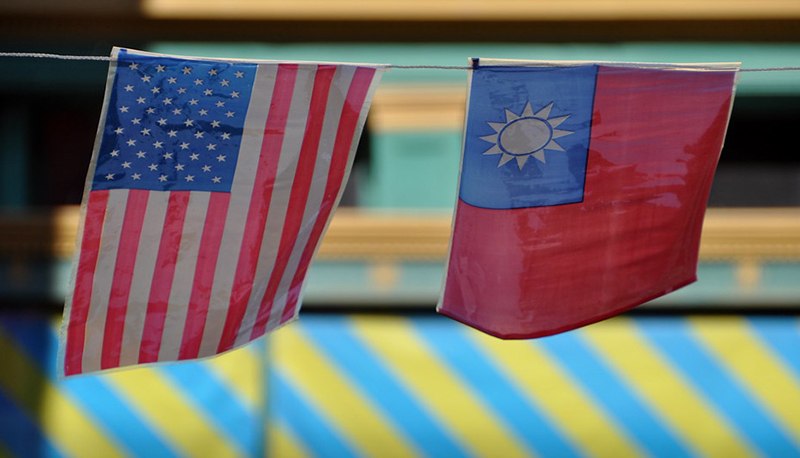 The United States and Taiwan national flags hang from the same banner