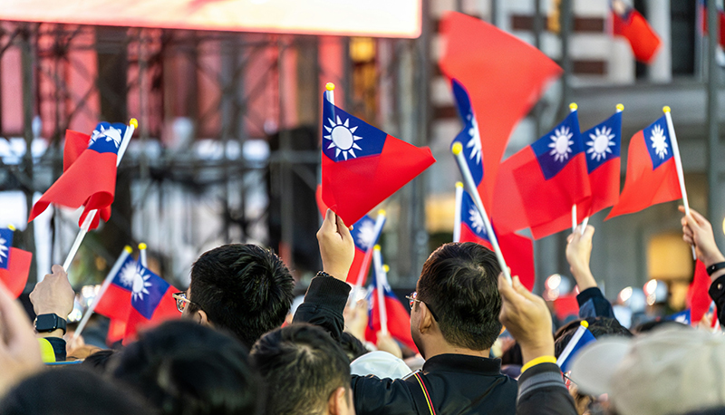 A group of people holding Taiwanese national flags