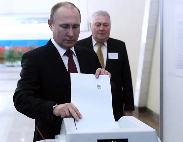Vladimir Putin casts his ballot in the presidential election in Russia, 2018.