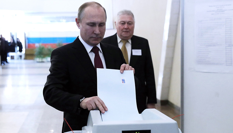 Vladimir Putin casts his ballot in the presidential election in Russia, 2018.