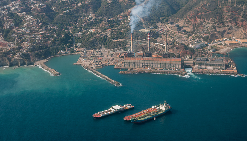 Aerial view of commercial ships and an electrical plant off Venezuela's Maiquetía coast