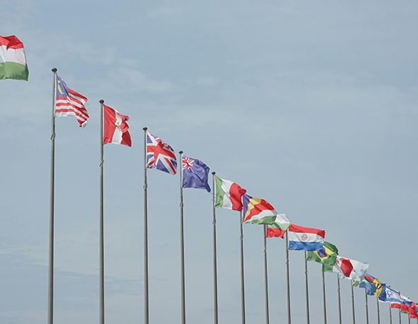 Photo of the sky view with different countries flags lined up in a row.