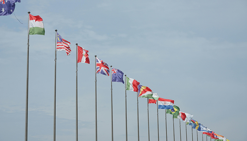 Photo of the sky view with different countries flags lined up in a row.