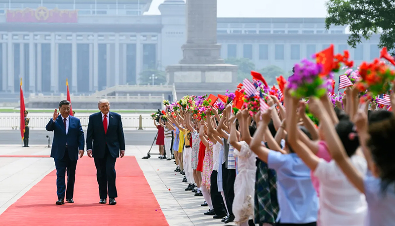 President Donald Trump is welcome to Beijing by Xi Jinping and a crowd of Chinese schoolchildren during his recent visit to China.