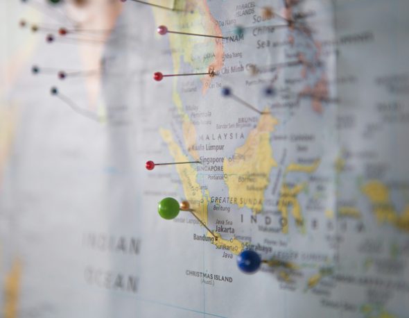 World map with pins on it.