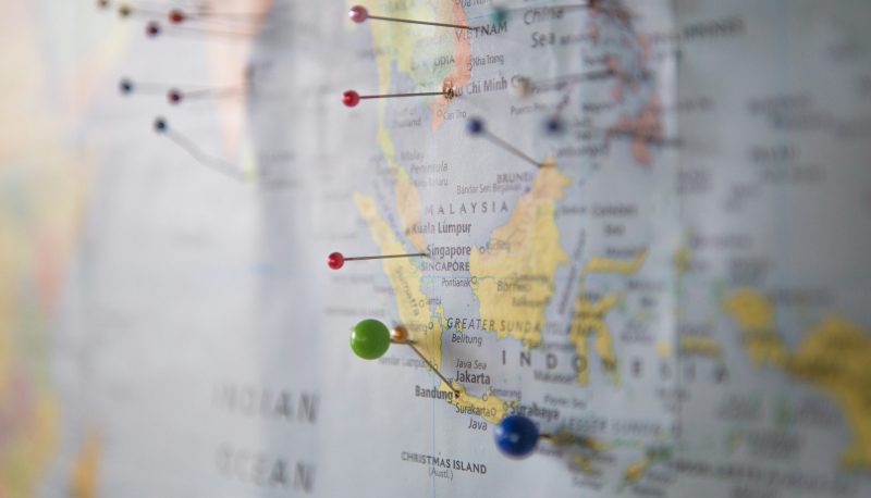 World map with pins on it.