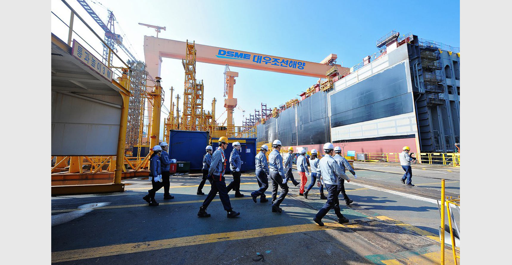 Workers touring the Daewoo Shipbuilding and Marine Engineering Shipyard (DSME) in South Korea, the second-largest shipbuilder in the world