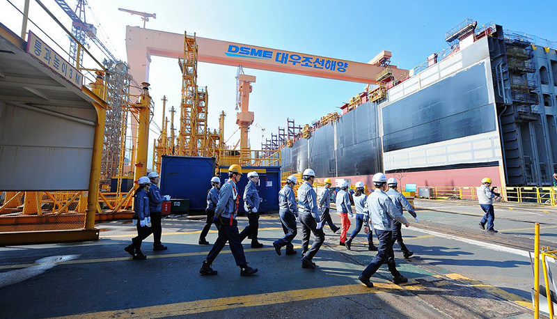 Workers touring the Daewoo Shipbuilding and Marine Engineering Shipyard (DSME) in South Korea, the second-largest shipbuilder in the world